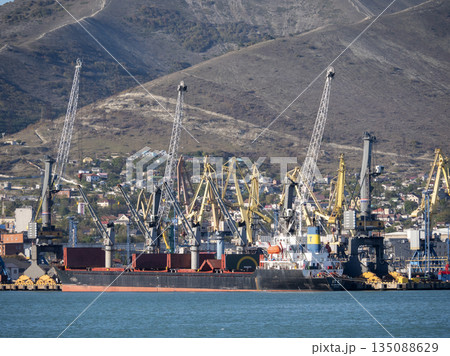 August 22 2025 View of Novorossiysk port Russia with cargo ships and cranes on the coastline. Industrial maritime scene on the Black Sea 135088629