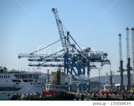 August 22 2025 View of Novorossiysk port Russia with cargo ships and cranes on the coastline. Industrial maritime scene on the Black Sea August 22 2025 View of Novorossiysk port Russia with cargo ships and cranes on the coastline. Industrial maritime scene on the Black Sea 135088634
