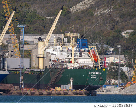 August 22 2025 View of Novorossiysk port Russia with cargo ships and cranes on the coastline. Industrial maritime scene on the Black Sea August 22 2025 View of Novorossiysk port Russia with cargo ships and cranes on the coastline. Industrial maritime scene on the Black Sea 135088637