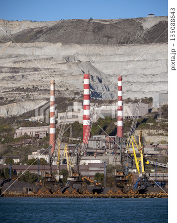 August 22 2025 View of Novorossiysk port Russia with cargo ships and cranes on the coastline. Industrial maritime scene on the Black Sea August 22 2025 View of Novorossiysk port Russia with cargo ships and cranes on the coastline. Industrial maritime scene on the Black Sea 135088643