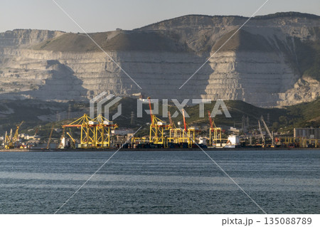 August 22 2025 View of Novorossiysk port Russia with cargo ships and cranes on the coastline. Industrial maritime scene on the Black Sea 135088789