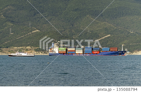 August 24, 2025: Large cargo ship entering the port of Novorossiysk, Russia, on the Black Sea, illustrating maritime transport, industrial shipping and coastal infrastructure August 24, 2025: Large cargo ship entering the port of Novorossiysk, Russia, on the Black Sea, illustrating maritime transport, industrial shipping and coastal infrastructure 135088794