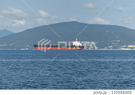 August 24, 2025: Large cargo ship entering the port of Novorossiysk, Russia, on the Black Sea, illustrating maritime transport, industrial shipping and coastal infrastructure 135088809