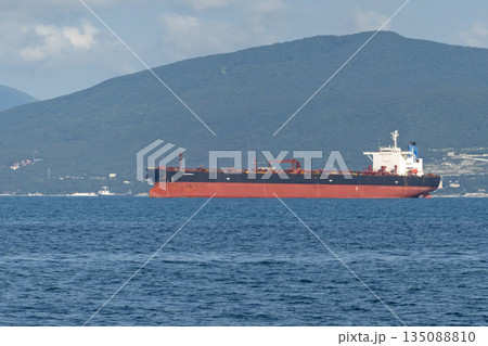 August 24, 2025: Large cargo ship entering the port of Novorossiysk, Russia, on the Black Sea, illustrating maritime transport, industrial shipping and coastal infrastructure 135088810
