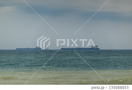 August 24, 2025: Large cargo ship entering the port of Novorossiysk, Russia, on the Black Sea, illustrating maritime transport, industrial shipping and coastal infrastructure August 24, 2025: Large cargo ship entering the port of Novorossiysk, Russia, on the Black Sea, illustrating maritime transport, industrial shipping and coastal infrastructure 135088853