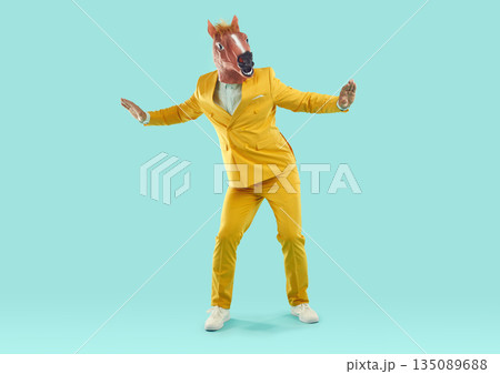 Man wearing horse head mask dancing in studio Man wearing horse head mask dancing in studio 135089688
