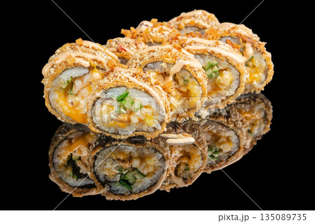 Crispy sushi rolls filled with vegetables and cheese are drizzled with creamy sauce and beautifully reflected on a glossy black surface Crispy sushi rolls filled with vegetables and cheese are drizzled with creamy sauce and beautifully reflected on a glossy black surface 135089735