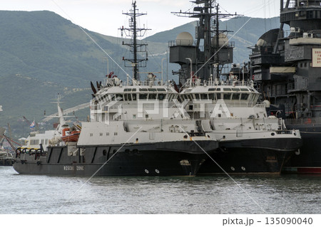 August 24, 2025: Rescue ships docked in the port of Novorossiysk, Russia, with mountains in the background, illustrating maritime safety, port operations and Black Sea coastal activity August 24, 2025: Rescue ships docked in the port of Novorossiysk, Russia, with mountains in the background, illustrating maritime safety, port operations and Black Sea coastal activity 135090040