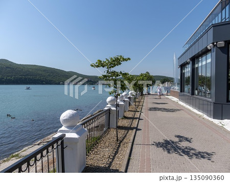 August 19, 2025 The promenade along Lake Abrau-Dyurso with calm water, greenery, and scenic surroundings 135090360