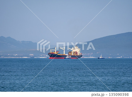 August 12, 2025: Cargo ship MSC Pamira III entering the port of Novorossiysk, Russia, navigating through calm waters with port activity in the background August 12, 2025: Cargo ship MSC Pamira III entering the port of Novorossiysk, Russia, navigating through calm waters with port activity in the background 135090398