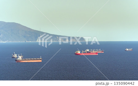 August 22 2025 Oil tankers waiting for loading in Tsemesskaya Bay near Novorossiysk Russia on the Black Sea. Large vessels anchored offshore 135090442