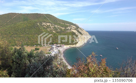 Scenic view of Durso beach with clear sea and mountain landscape, showcasing natural coastline, summer atmosphere and peaceful seaside environment in southern Russia Scenic view of Durso beach with clear sea and mountain landscape, showcasing natural coastline, summer atmosphere and peaceful seaside environment in southern Russia 135090706