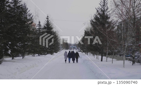 28 December 2025, Barnaul, Russia. People walk along the central city alley in winter, enjoying snowy urban streets, seasonal outdoor activities, and cityscape. 135090740