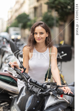 Young woman rents bike on city street Young woman rents bike on city street 135091334