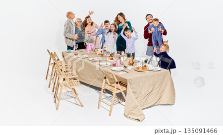 Cheerful family interaction during relaxed home gathering. Cheerful family interaction during relaxed home gathering. 135091466