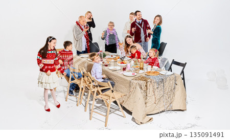 Cheerful family celebrating Lunar New Year with food and drinks. 135091491