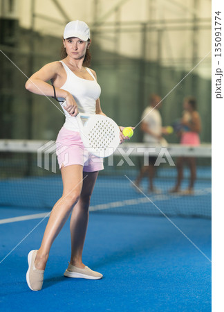 Adult woman posing on tennis court 135091774