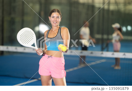 Young woman posing on tennis court Young woman posing on tennis court 135091879