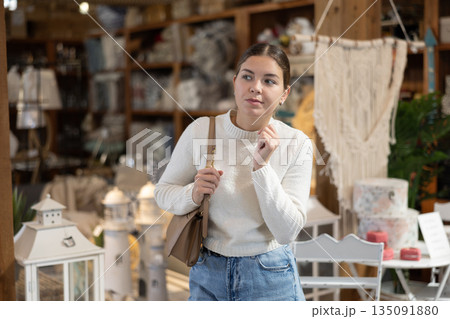 Young woman choosing furniture in store Young woman choosing furniture in store 135091880