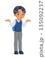 Confused Asian school boy shrugging shoulders. Cartoon vector illustration. 135092237