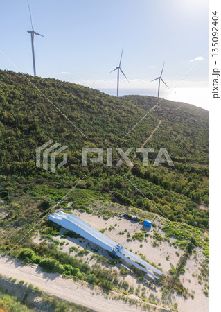 Wind turbines on the top of the mountain with spare blades on the ground. Wind generator repairing 135092404