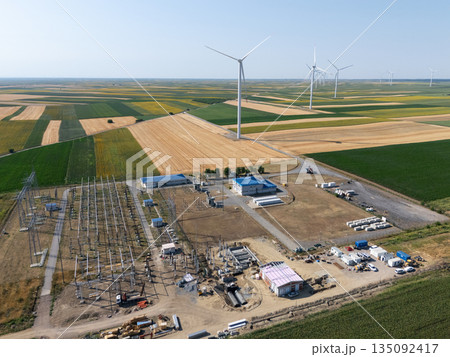 Aerial view of wind turbines with electric power station. Aerial view of wind turbines with electric power station. 135092417