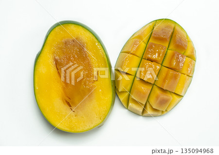 Inside of a very ripe mango sliced in half on white background 135094968