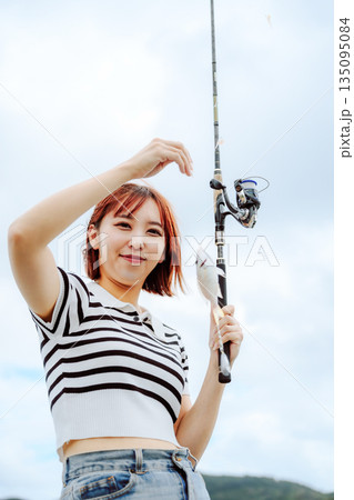 釣りを楽しむ女性とれたての魚と釣り竿を持つ女性 【撮影協力：隠岐シーサイドリゾートみやび様】 135095084