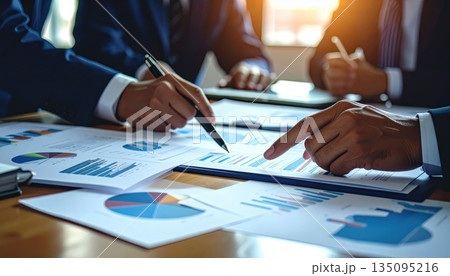 Business people shaking hands on a contract after a productive team meeting in the office 135095216
