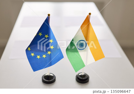 EU and India desk flags symbolizing diplomacy, negotiation and bilateral meeting EU and India desk flags symbolizing diplomacy, negotiation and bilateral meeting 135096647