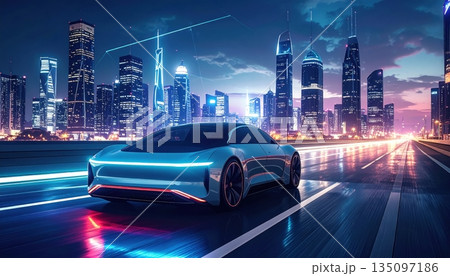 Urban traffic flows through the downtown city street at night as cars drive past illuminated skyscrapers and office buildings in a high speed motion across the highway 135097186