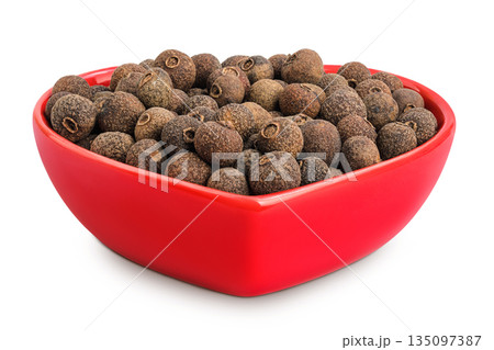 Allspice pepper in ceramic bowl isolated on white background. Jamaica pepper, Pimenta dioica or myrtle pepper. 135097387