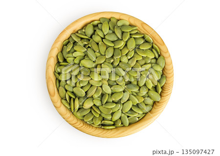Peeled pumpkin seeds in wooden bowl isolated on white background. Top view. Flat lay Peeled pumpkin seeds in wooden bowl isolated on white background. Top view. Flat lay 135097427