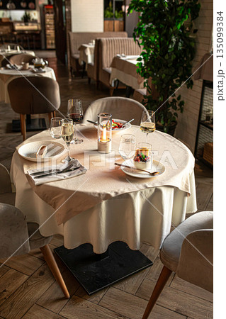 Restaurant table setup with candlelight and wine 135099384