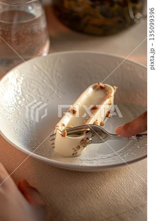 Creamy restaurant dessert with nut crumble 135099396