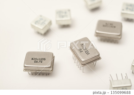 Old chips on a white background. Different electronic chips. Microcircuits in a metal case. Old chips on a white background. Different electronic chips. Microcircuits in a metal case. 135099688