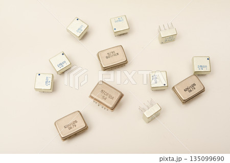 Old chips on a white background. Different electronic chips. Microcircuits in a metal case. Old chips on a white background. Different electronic chips. Microcircuits in a metal case. 135099690