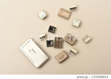 Old chips on a white background. Different electronic chips. Microcircuits in a metal case. 135099691