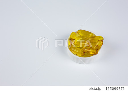 Recommended use of Omega 3 vitamin in gelatin capsule with fish oil. Universal dietary supplement for taking with food. Concept of medical, health and wellness. Vitamins for elderly and young 135099773