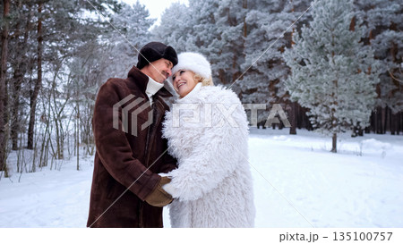 Couple Hugs Outdoors, Romantic Couple Celebrating Marriage During Winter Outdoor Photo Shoot, Brightly Dressed Newlyweds Exchange Warm Embraces Amidst Snowy Trees During Intimate Wedding Photography Couple Hugs Outdoors, Romantic Couple Celebrating Marriage During Winter Outdoor Photo Shoot, Brightly Dressed Newlyweds Exchange Warm Embraces Amidst Snowy Trees During Intimate Wedding Photography 135100757