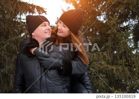 Couple Enjoying Tender Outdoor Moment, Intimate Couple Sharing Warm Weather Affection Outside, Couple Expressing Love Through Gentle Caresses Amid Beautiful Natural Landscape In Warm Clothing 135100819