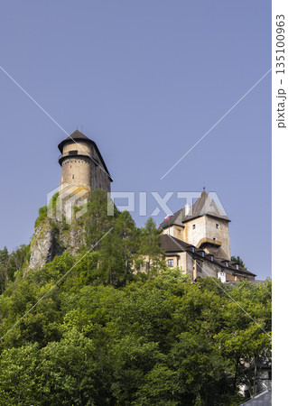 Orava Castle fortified stronghold rising above trees 135100963