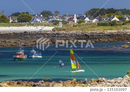 Coastal village with beach and water sports activity on a sunny day in Brittany Coastal village with beach and water sports activity on a sunny day in Brittany 135101097