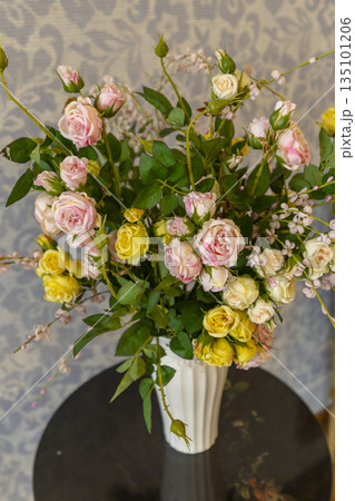 Rose bouquet in vase bringing floral decoration indoors Rose bouquet in vase bringing floral decoration indoors 135101206