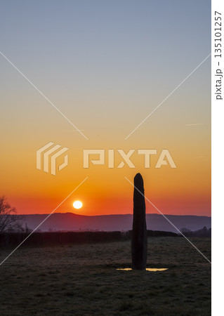 Ancient standing stone at sunrise in Bourgogne Franche Comte 135101257