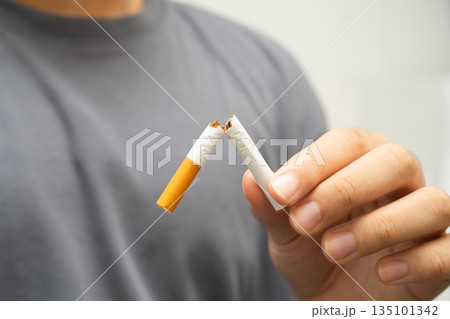 Quit smoking, Asian teenage man breaking destroy cigarette in hand. 135101342