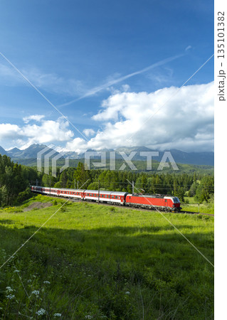 Train traveling through scenic High Tatras mountains in Slovakia Train traveling through scenic High Tatras mountains in Slovakia 135101382