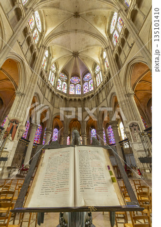 Ancient bible open on lectern in Auxerre cathedral interior Ancient bible open on lectern in Auxerre cathedral interior 135101410
