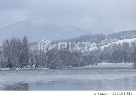 Winter landscape with Vah river and snow covered trees in Strecno 135101433