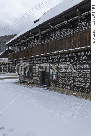 Cicmany painted folk house with traditional patterns in winter 135101491